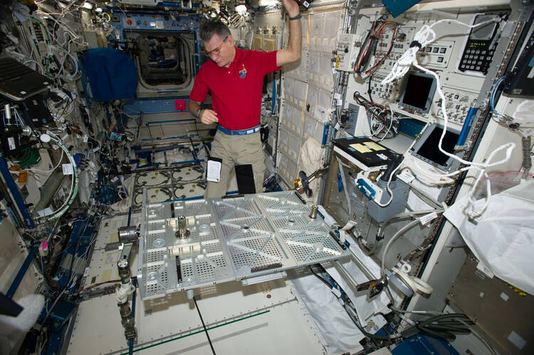 In this photo provided the European Space Agency on Wednesday, Oct. 25, 2017, Italian astronaut Paolo Nespoli looks at the Multipurpose Transporting Plate aboard the International Space Station. Pope Francis is making his first phone call off the planet - and into space. On Thursday, Oct. 26 the pope will reach out to the six astronauts on the International Space Station. It will be only the second time a pope phones the heavens like this. Pope Benedict XVI called the space station in 2011. Nespoli was aboa