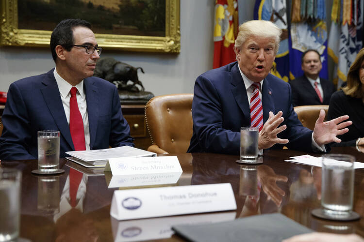 Treasury Secretary Steve Mnuchin listens as President Donald Trump speaks during a meeting on tax policy with business leaders in the Roosevelt Room of the White House, Tuesday, Oct. 31, 2017, in Washington. (AP Photo/Evan Vucci)