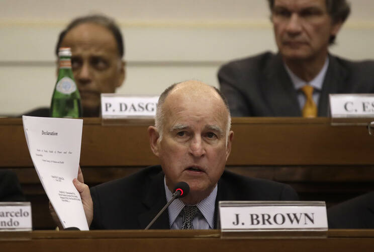 California Gov. Jerry Brown shows a paper during a workshop organized by Vatican on the climate change, at the Casina Pio IV, at the Vatican, Saturday Nov.4, 2017. 