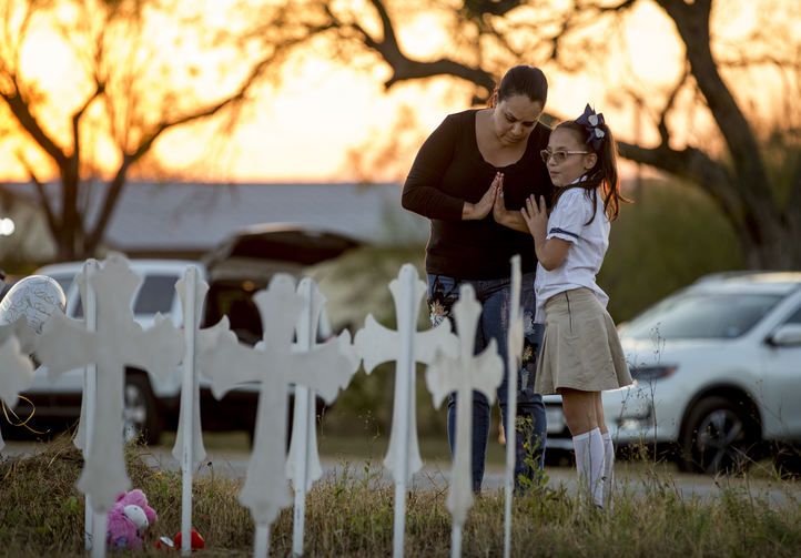 Meredith Cooper, of San Antonio, Tex., and her 8-year-old daughter, Heather, visit a memorial of 26 metal crosses near First Baptist Church in Sutherland Springs, Tex., on Nov. 6. (Jay Janner/Austin American-Statesman via AP)