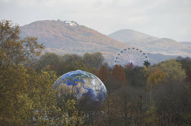 A globe and a Ferris Wheel stand in the forest near Bonn, Germany, on Monday, Nov. 13, 2017. The UN Climate Conference takes place in Bonn, Germany till Nov. 17, 2017. (Rainer Jensen/dpa via AP)