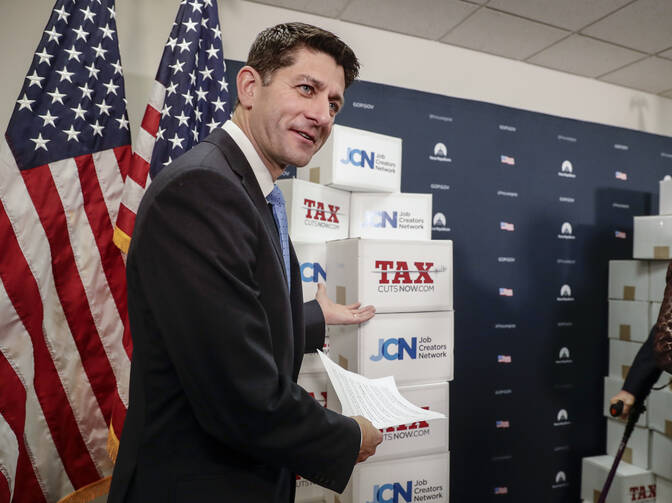 Speaker of the House Paul Ryan, R-Wis., points to boxes of petitions supporting the Republican tax reform bill that is set for a vote later this week as he arrives for a news conference on Capitol Hill in Washington, Tuesday, Nov. 14, 2017. (AP Photo/J. Scott Applewhite)