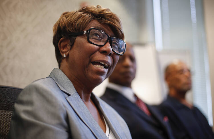 In this Aug. 23, 2017, file photo, Barbara Butler, accompanied by her husband Phillip, speaks during a news conference at their attorney's office in Washington. Four decades after a Catholic priest who was once a member of the Ku Klux Klan burned a cross on the couple's lawn, he finally wrote them an apology. (AP Photo/Pablo Martinez Monsivais, File)
