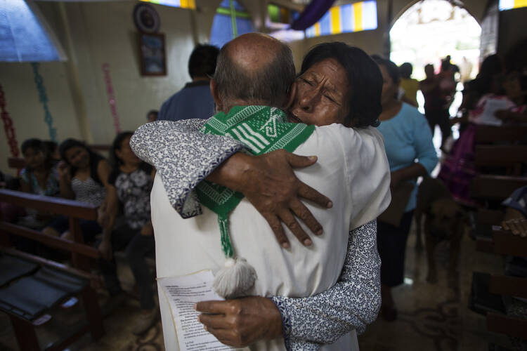 In this Jan. 14, 2018 photo, parishioner Lucero Fatima Cusi embraces Father Pablo Zabala, better known as Padre Pablo, during his last day as parish priest in Boca Colorado, part of Peru’s Madre de Dios region. After 10 years of service there, the 70-year-old Spanish priest has been transferred 130 kms (80 miles) away to Puerto Maldonado, known as the gateway to the Amazon jungle. (AP Photo/Rodrigo Abd)