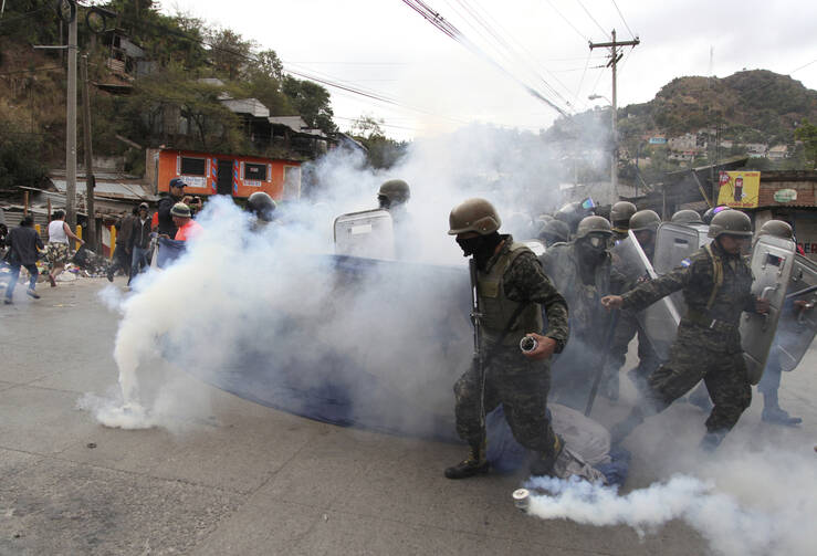 Supporters of opposition presidential candidate Salvador Nasralla clash with military police in the Policarpo Paz Garcia neighborhood of Tegucigalpa, Honduras, on Jan. 20, 2018. Following a disputed election marred by irregularities, incumbent President Juan Orlando Hernandez was declared the victor and will be inaugurated on Jan. 27. The opposition does not recognize Hernandez's victory and are protesting against the result. (AP Photo/Fernando Antonio)
