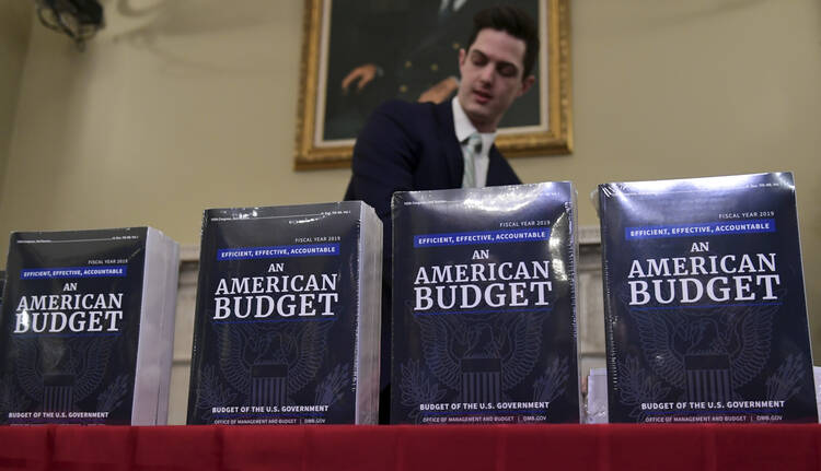 James Knable helps to unpack copies of the President's FY19 Budget after it arrived at the House Budget Committee office on Capitol Hill in Washington, Monday, Feb. 12, 2018. (AP Photo/Susan Walsh)