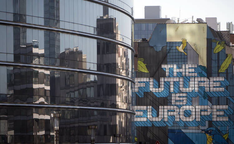 The glass front of a building which houses the translators of the European Commission in Brussels on March 20, 2018. (AP Photo/Virginia Mayo)