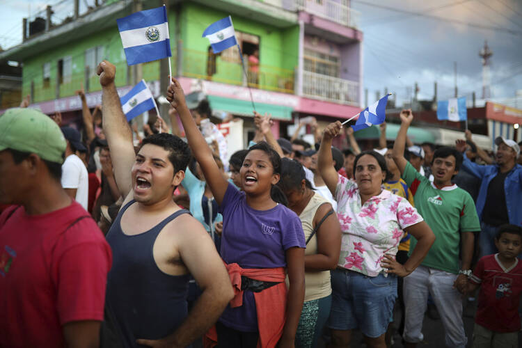 Central American migrants traveling with the annual Stations of the Cross caravan march to call for migrants' rights and protest the policies of U.S. President Donald Trump and Honduran President Juan Orlando Hernandez, in Matias Romero, Oaxaca State, Mexico, Tuesday, April 3, 2018. (AP Photo/Felix Marquez)