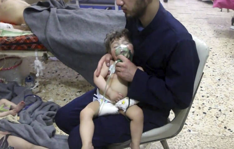 A medical worker gives a child oxygen following an alleged poison gas attack in the opposition-held town of Douma, near Damascus, Syria, on April 8. (Syrian Civil Defense White Helmets via AP)