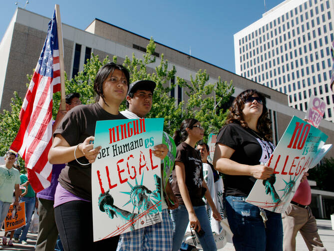 In this June 15, 2010, file photo, immigration reform advocates march around the Federal Courthouse in downtown Denver. (AP Photo/David Zalubowski, File)
