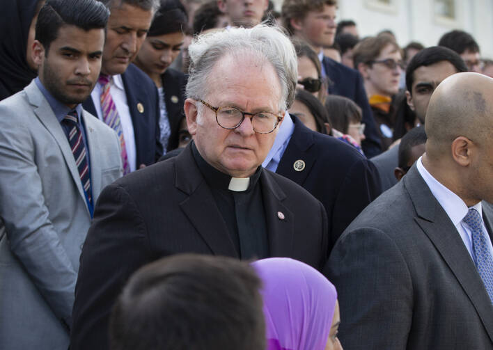In this June 2016 photo, Patrick Conroy, S.J., chaplain of the House of Representatives, delivers an interfaith message on the steps of the Capitol in Washington for the victims of the mass shooting at an LGBT nightclub in Orlando. (AP Photo/J. Scott Applewhite)