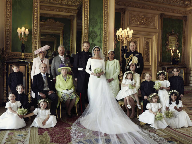 An official wedding photo of Britain's Prince Harry and Meghan Markle, center, in Windsor Castle, Windsor, England. Others in photo from left, back row, Jasper Dyer, Camilla, Duchess of Cornwall, Prince Charles, Doria Ragland, Prince William; center row, Brian Mulroney, Prince Philip, Queen Elizabeth II, Kate, Duchess of Cambridge, Princess Charlotte, Prince George, Rylan Litt, John Mulroney; front row, Ivy Mulroney, Florence van Cutsem, Zalie Warren, Remi Litt. (Alexi Lubomirski/Kensington Palace via AP)