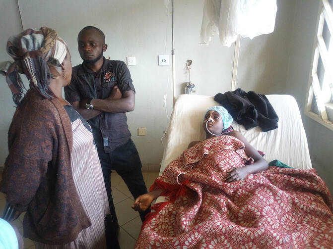 A child receives treatment at the Jos University teaching hospital in Jos, Nigeria, on June 25, 2018, after clashes in central Nigeria between mostly Muslim herders and Christian farmers. Dramatic footage from Jos showed angry people waving machetes and sticks and shouting at passing security forces as they weaved around overturned and burning vehicles. (AP Photo)