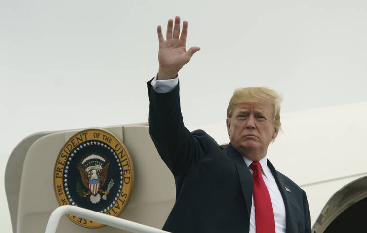 President Donald Trump waves as he boards Air Force One at Morristown Municipal Airport, in Morristown, N.J., Sunday, July 22, 2018, en route to Washington after staying at Trump National Golf Club in Bedminster, N.J. (AP Photo/Carolyn Kaster)