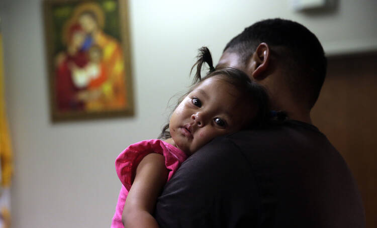 Honduras immigrant seeking asylum, Carlos Fuentes Maldonado holds his daughter Mia, 1, after they were reunited, Monday, July 23, 2018, in San Antonio. (AP Photo/Eric Gay)