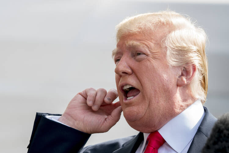 President Donald Trump speaks to members of the media before boarding Marine One on the South Lawn of the White House on Aug. 17, 2018. (AP Photo/Andrew Harnik)