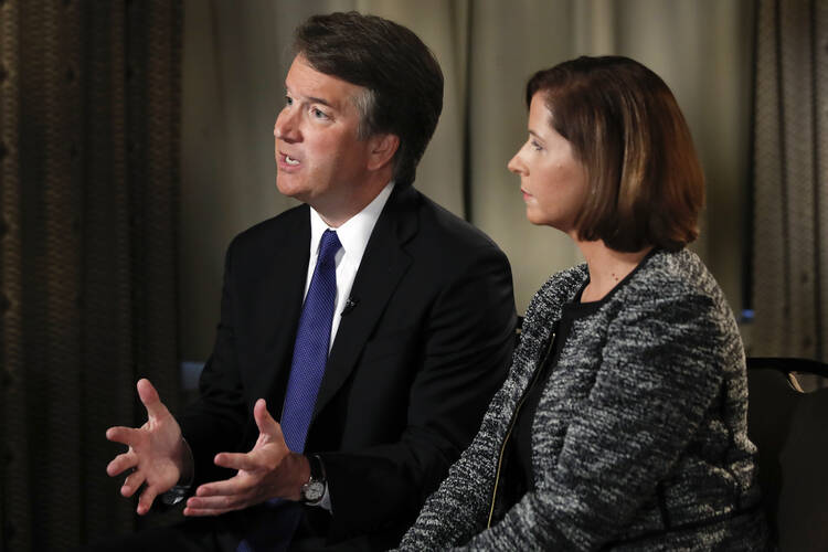 Brett Kavanaugh, with his wife Ashley Estes Kavanaugh, answers questions during a FOX News interview on Sept. 24 about allegations of sexual misconduct against the Supreme Court nominee. (AP Photo/Jacquelyn Martin)