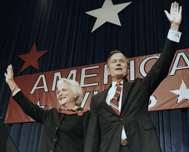 In this Nov. 8, 1988 file photo, President-elect George H.W. Bush and his wife Barbara wave to supporters in Houston, Texas after winning the presidential election. (AP Photo/Scott Applewhite, File)​​​​​​​