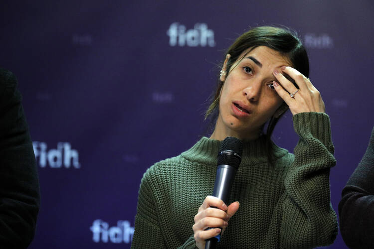 Nadia Murad, a Yazidi who escaped the Islamic State and a co-recipient of this year's Nobel Peace Prize, reacts while speaking at a news conference at the International Federation for Human Rights office in Paris on Oct. 25. An international human rights group says foreign fighters, including many Europeans, were responsible for carrying out the Islamic State group's atrocities against minority Yazidis. (AP Photo/Francois Mori)