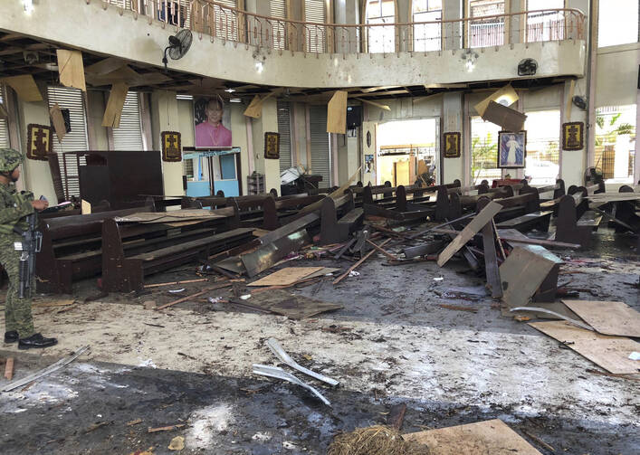 A soldier inside a Roman Catholic cathedral in Jolo, the capital of Sulu province in the southern Philippines, after two bombs exploded on Jan. 27. (WESMINCOM Armed Forces of the Philippines Via AP)