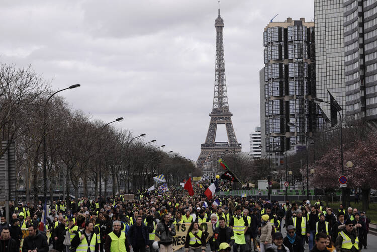 Yellow Vest Protesters march near the Eiffel Tower in Paris on March 2. (AP Photo/Kamil Zihnioglu)