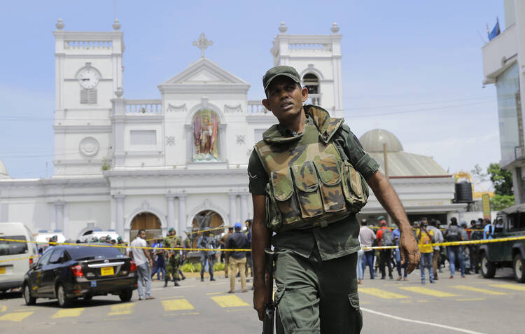 Sri Lankan Army soldiers secure the area around St. Anthony's Shrine after a blast in Colombo, Sri Lanka, Sunday, April 21, 2019. Witnesses are reporting two explosions have hit two churches in Sri Lanka on Easter Sunday, causing casualties among worshippers. (AP Photo/Eranga Jayawardena)