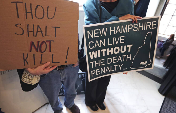 Protestors gather outside the Senate Chamber prior to a vote on the death penalty at the State House in Concord, N.H., Thursday, May 30, 2019. New Hampshire, which hasn't executed anyone in 80 years and has only one inmate on death row, on Thursday became the latest state to abolish the death penalty when the state Senate voted to override the governor's veto. (AP Photo/Charles Krupa)