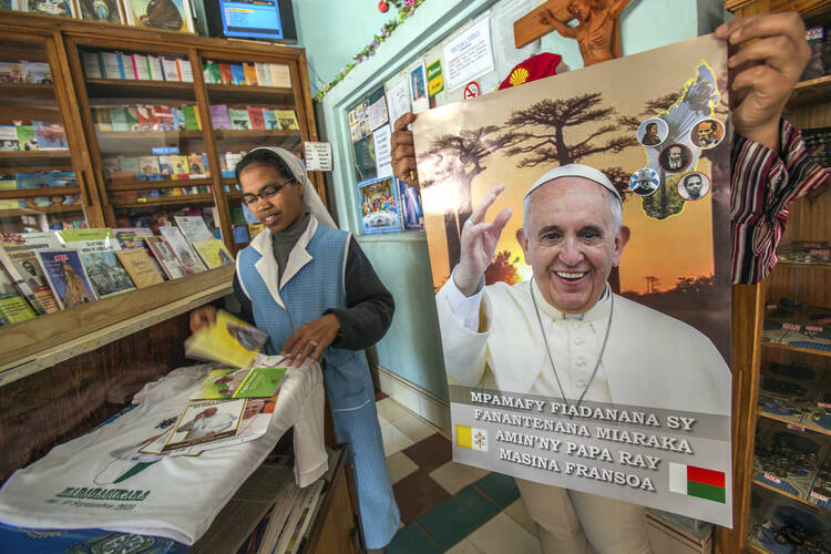 A Catholic sister browses in a store with Pope paraphernalia in Antananarivo, Madagascar, on Sept. 3. (AP Photo/Alexander Joe)