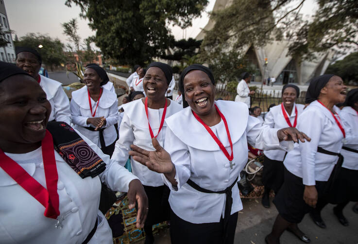 Women from different churches sing as they wait to see Pope Francis, ahead of his arrival at the Apostolic Nunciature in the capital Maputo, Mozambique, on Wednesday, Sept. 4, 2019. Pope Francis is opening a three-nation pilgrimage to southern Africa with a strategic visit to Mozambique, just weeks after the country's ruling party and armed opposition signed a new peace deal and weeks before national elections. (AP Photo/Ben Curtis)