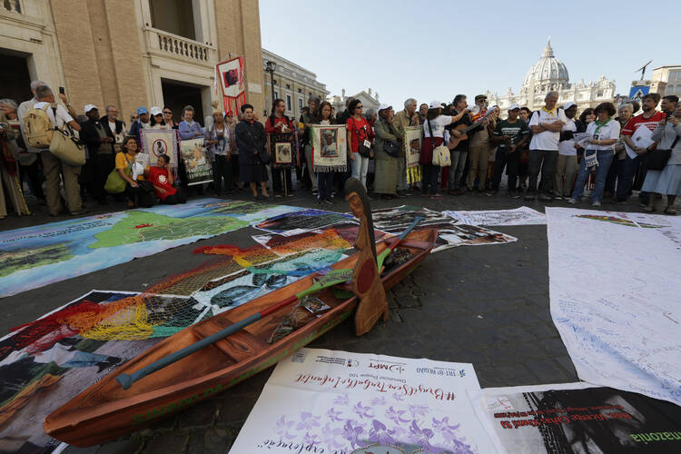 Members of Amazon indigenous populations pray at the end a Via Crucis procession from St. Angelo Castle to the Vatican, Saturday, on Oct. 19, 2019. Pope Francis is holding a three-week meeting on preserving the rainforest and ministering to its native people as he fended off attacks from conservatives who are opposed to his ecological agenda. (AP Photo/Andrew Medichini)