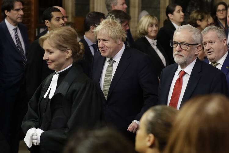 Britain's Prime Minister Boris Johnson and opposition Labour Party Leader Jeremy Corbyn, right, walk through the Commons Members Lobby, during the state opening of Parliament, in London on Dec. 19. (AP Photo/Kirsty Wigglesworth, Pool)