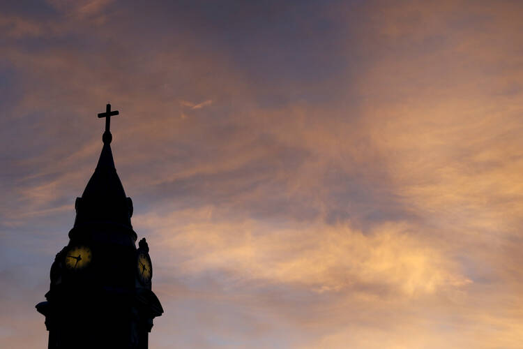 Clouds are lit by the rising sun over St. Augustine Roman Catholic Church in Philadelphia in this 2015 file photo.  (AP Photo/Julio Cortez)