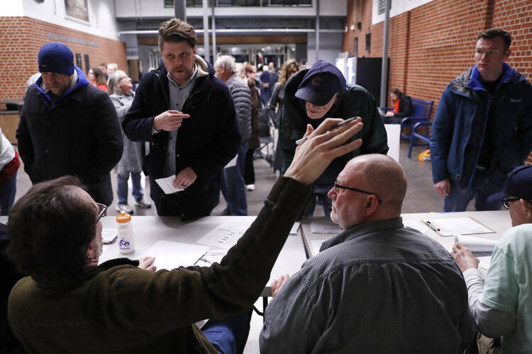 Caucus goers check in at Roosevelt High School on Feb. 3 in Des Moines, Iowa. (AP Photo/Andrew Harnik)