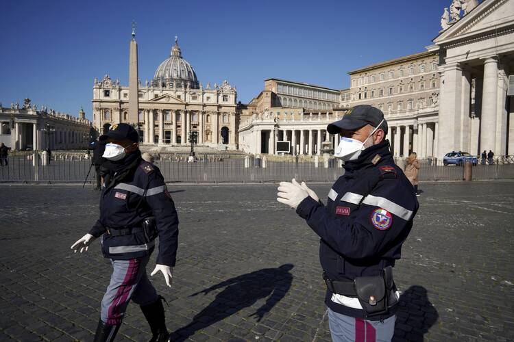 Police officers patrol an empty St. Peter's Square at the Vatican on Wednesday, March 11. (AP Photo/Andrew Medichini)