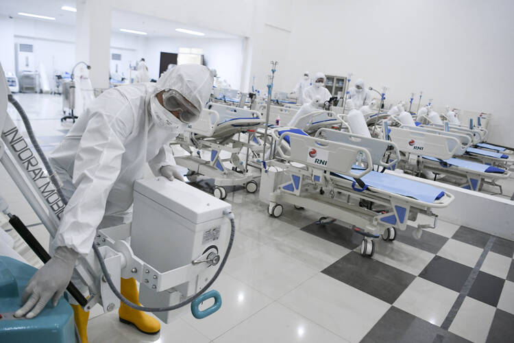 Staff inspect medical equipment at an emergency hospital set up amid the coronavirus outbreak in Jakarta, Indonesia, on, March 23. (Hafidz Mubarak A/Pool Photo via AP)