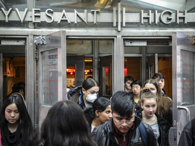 Students at New York City's Stuyvesant High School leave classes on March 13. Schools in New York City have since been closed for the rest of the academic year. (AP Photo/Bebeto Matthews, File)