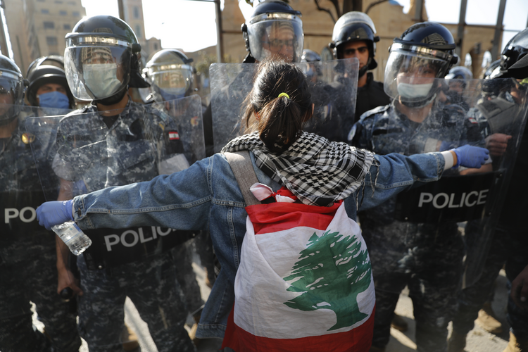 Image: An anti-government protester confronts security during a protest against the deepening financial crisis, in Beirut, Lebanon, on April 28. (AP Photo/Hussein Malla)