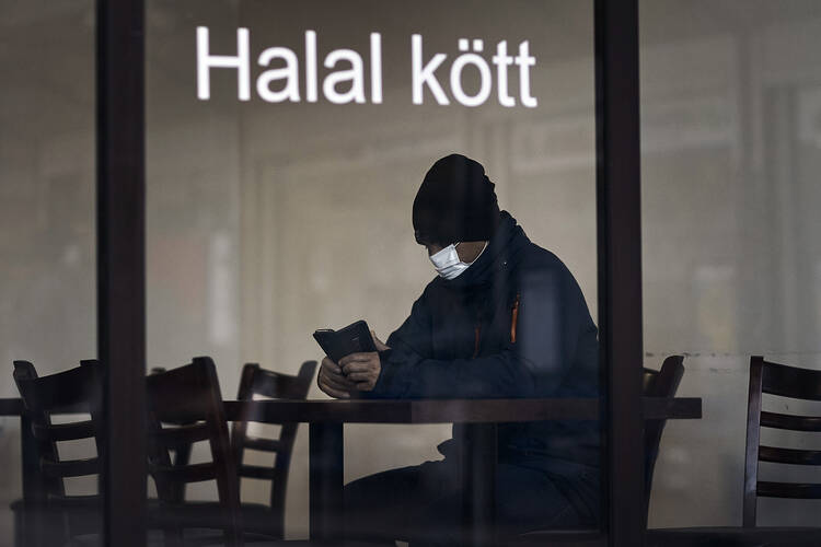 A solitary customer in a restaurant in Stockholm, Sweden, on April 28. (AP Photo/Andres Kudacki)
