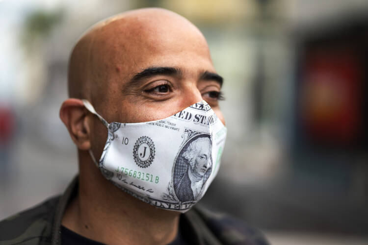 A man waits in line for food assistance during the lockdown to contain Covid-19 in Montevideo, Uruguay, on April 25. (AP Photo/Matilde Campodonico)