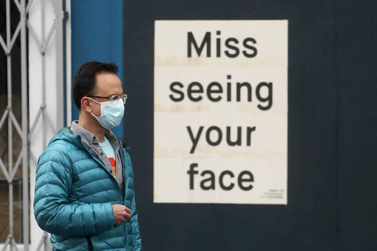 “Should I wear a mask to the grocery store?” is one of the new questions about our responsibilities to others. Photo taken outside a business in San Francisco on April 11. (AP Photo/Jeff Chiu, File)