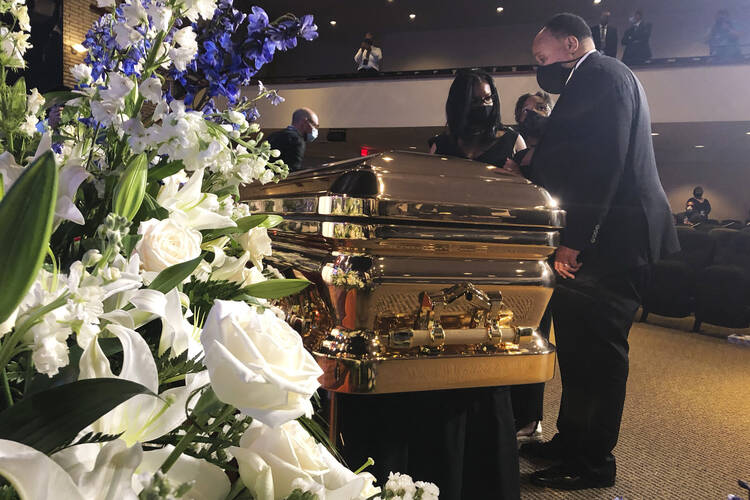 Martin Luther King III takes a moment by George Floyd's casket Thursday, June 4, 2020, before a memorial service for George Floyd in Minneapolis. (AP Photo/Bebeto Matthews)