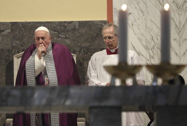 Pope Francis coughs inside the Basilica of Saint Anselmo prior to the start of a procession to the Basilica of Santa Sabina before the Ash Wednesday Mass in Rome on Feb. 26. (AP Photo/Gregorio Borgia)