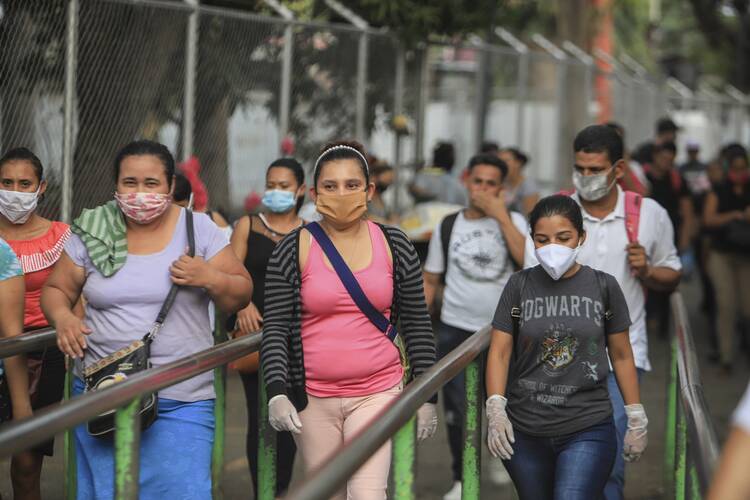 Workers wear masks as a protection against the spread of the new coronavirus as they leave from a day's work in Managua, Nicaragua, on May 11, 2020. (AP Photo/Alfredo Zuniga)