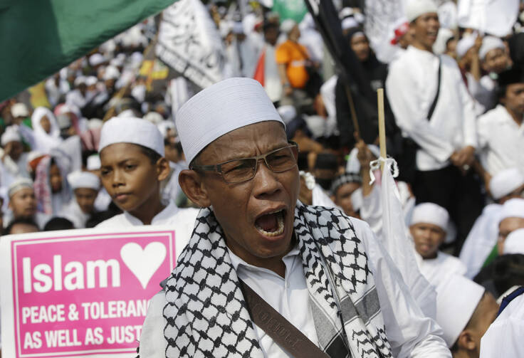 A muslim protester shouts slogans during a protest against Jakarta's Christian Governor Basuki "Ahok" Tjahaja Purnama in Jakarta, Indonesia, on Friday, May 5, 2017. (AP Photo/Achmad Ibrahim)