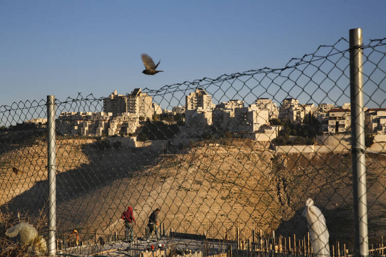 Palestinian laborers work at a construction site in a new housing project in the Israeli settlement of Maale Adumim, near Jerusalem, on Feb. 7, 2017. (AP Photo/Oded Balilty)