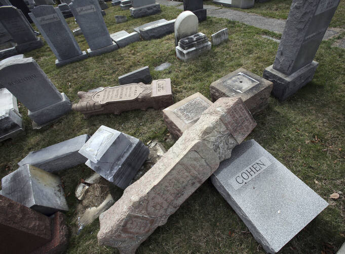 In this Monday, Feb. 27, 2017 file photo,toppled and damaged headstones rest on the ground at Mount Carmel Cemetery in Philadelphia. (AP Photo/Jacqueline Larma)