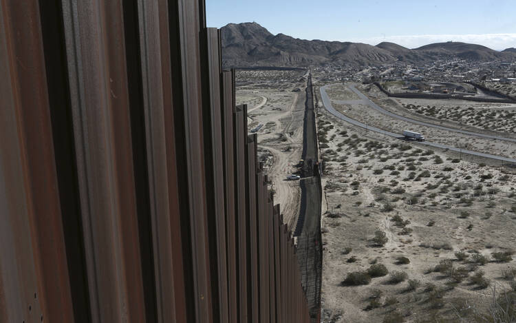 This Jan. 25, 2017, file photo shows a truck driving near the Mexico-US border fence, on the Mexican side, separating the towns of Anapra, Mexico and Sunland Park, New Mexico.  (AP Photo/Christian Torres, File)