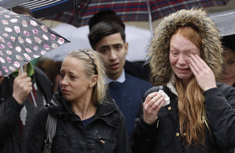 Londoners participate in a moment of silence on Tuesday morning to remember terrorist attack victims in the London Bridge area. (AP Photo/Matt Dunham)