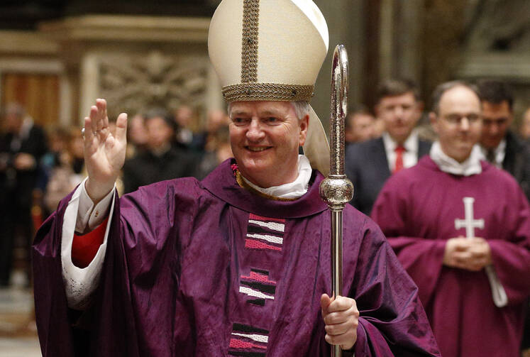 Newly ordained Bishop Paul Tighe, a priest of the Archdiocese of Dublin, greets the faithful during his ordination to the episcopate in St. Peter's Basilica at the Vatican Feb. 27, 2016 (CNS photo/Paul Haring).