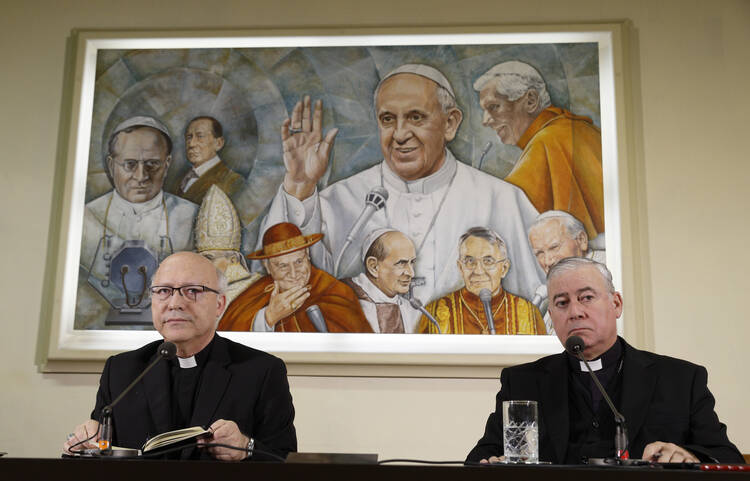  Auxiliary Bishop Fernando Ramos Perez of Santiago, Chile, and Bishop Juan Ignacio Gonzalez Errazuriz of San Bernardo, Chile, lead a press conference at the Vatican May 14. Pope Francis is meeting this week with Chile's bishops in the wake of a clerical sex abuse crisis. (CNS photo/Paul Haring)